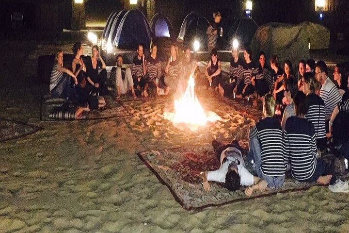 Experience the magic of the desert night around a warm campfire sharing stories under a sky filled with stars while enjoying traditional entertainment and delicious BBQ delights.